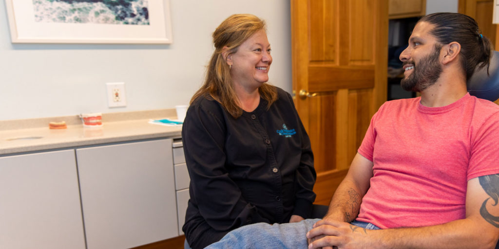 dental assistant discussing scaling and root planning procedure